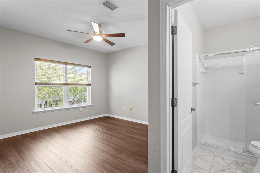 943 Normandy Trace Road Tampa, FL 33602 - Photo 20 of 51 a view of an empty room with wooden floor and a window