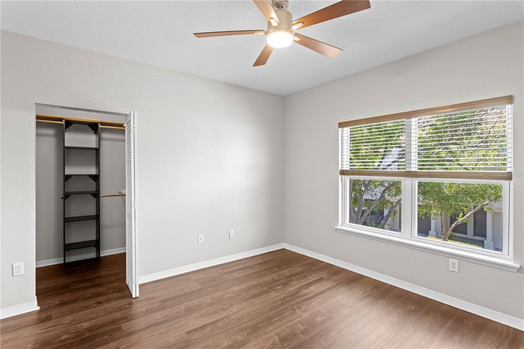943 Normandy Trace Road Tampa, FL 33602 - Photo 22 of 51 a view of an empty room with a window and wooden floor