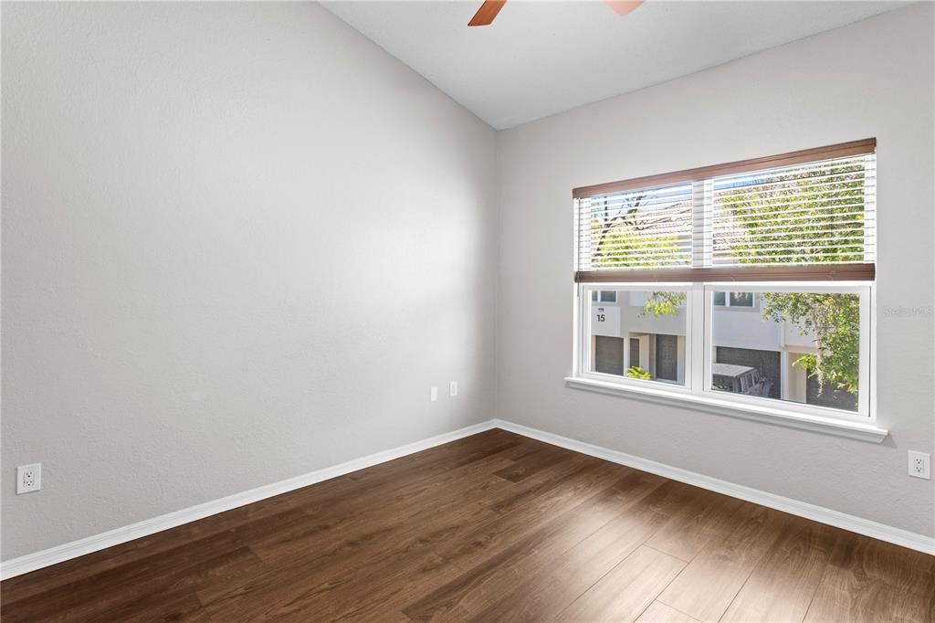 943 Normandy Trace Road Tampa, FL 33602 - Photo 27 of 51 a view of an empty room with wooden floor and a window