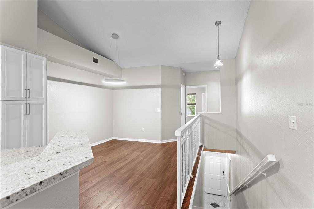 943 Normandy Trace Road Tampa, FL 33602 - Photo 7 of 51 a view of a livingroom with wooden floor and stairs