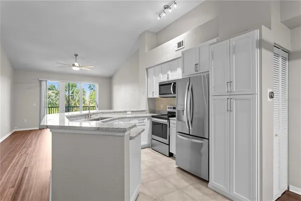 a kitchen with stainless steel appliances a refrigerator sink and stove