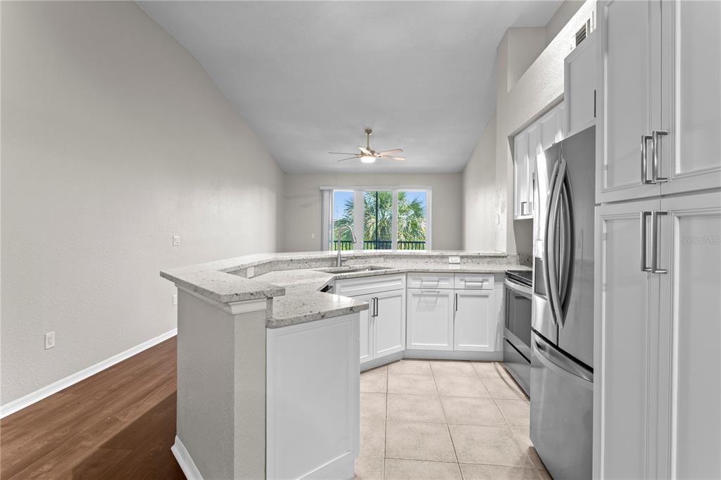 943 Normandy Trace Road Tampa, FL 33602 - Photo 9 of 51 a kitchen with stainless steel appliances granite countertop a refrigerator and a stove