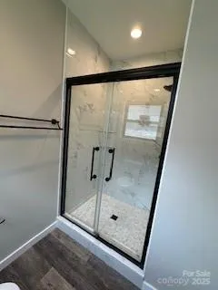 a bathroom with a glass shower door