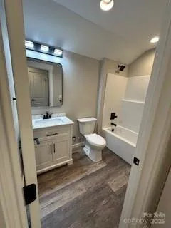 a bathroom with a sink a toilet a mirror and shower