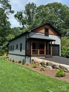 a front view of a house with a garden and yard