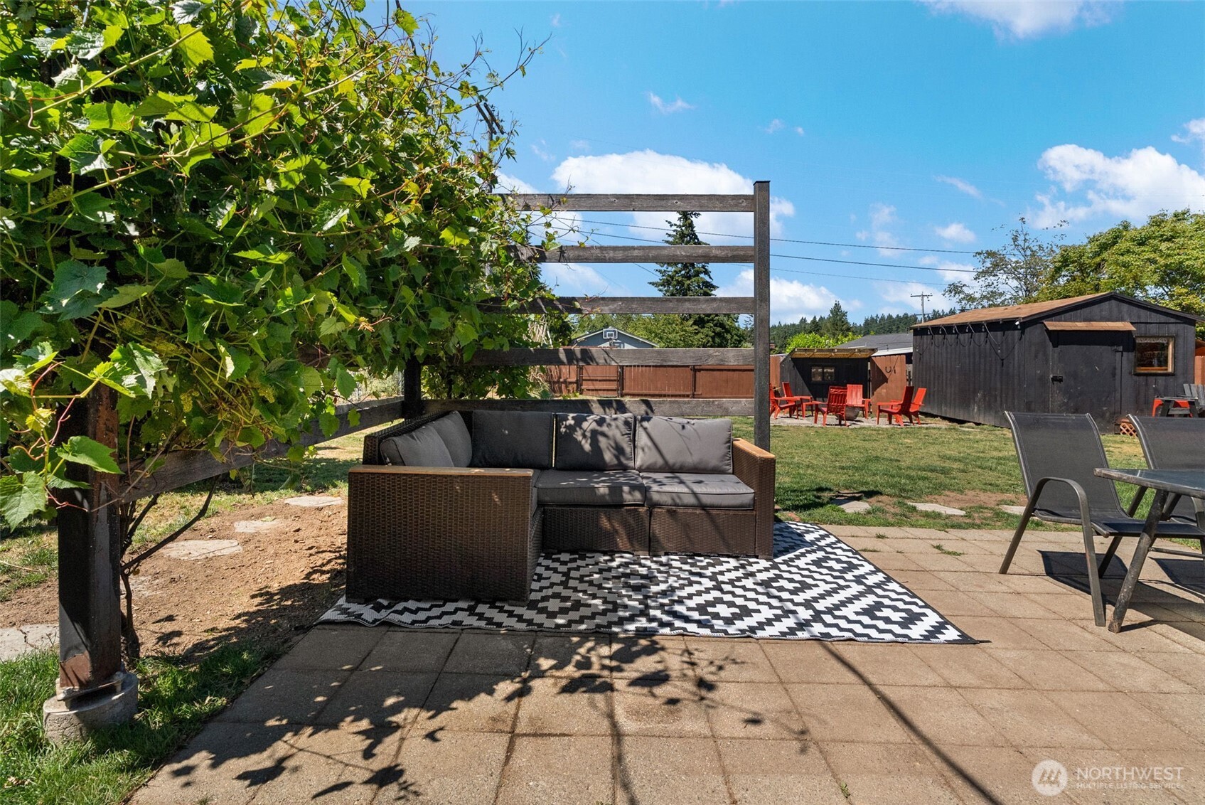 2710 Holman Street Bremerton, WA 98310 - Photo 21 of 25 a view of a patio with table and chairs barbeque potted plants and large tree