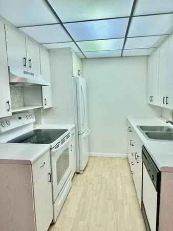 a kitchen with a sink stove and refrigerator