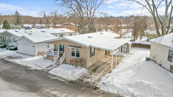 a view of a house with snow on the road