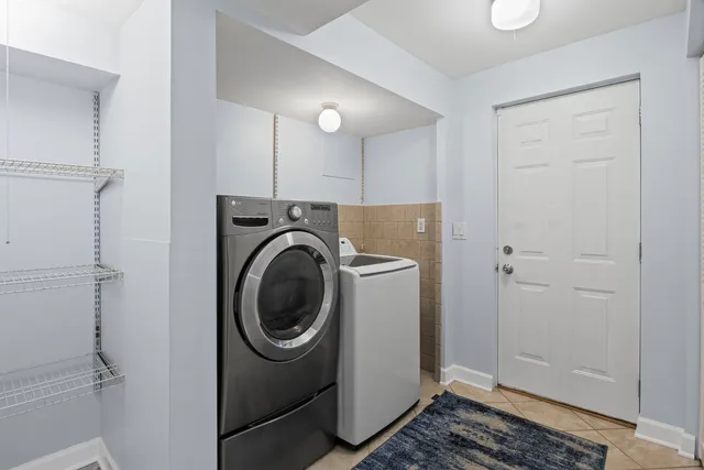 a view of a storage & utility room with a washer dryer