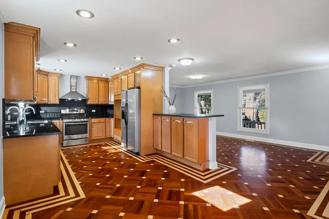 a kitchen with lots of counter top space and refrigerator