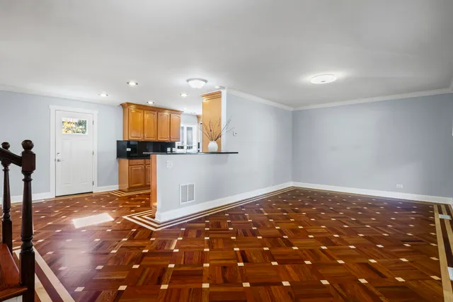 a view of a kitchen with wooden floor and a refrigerator