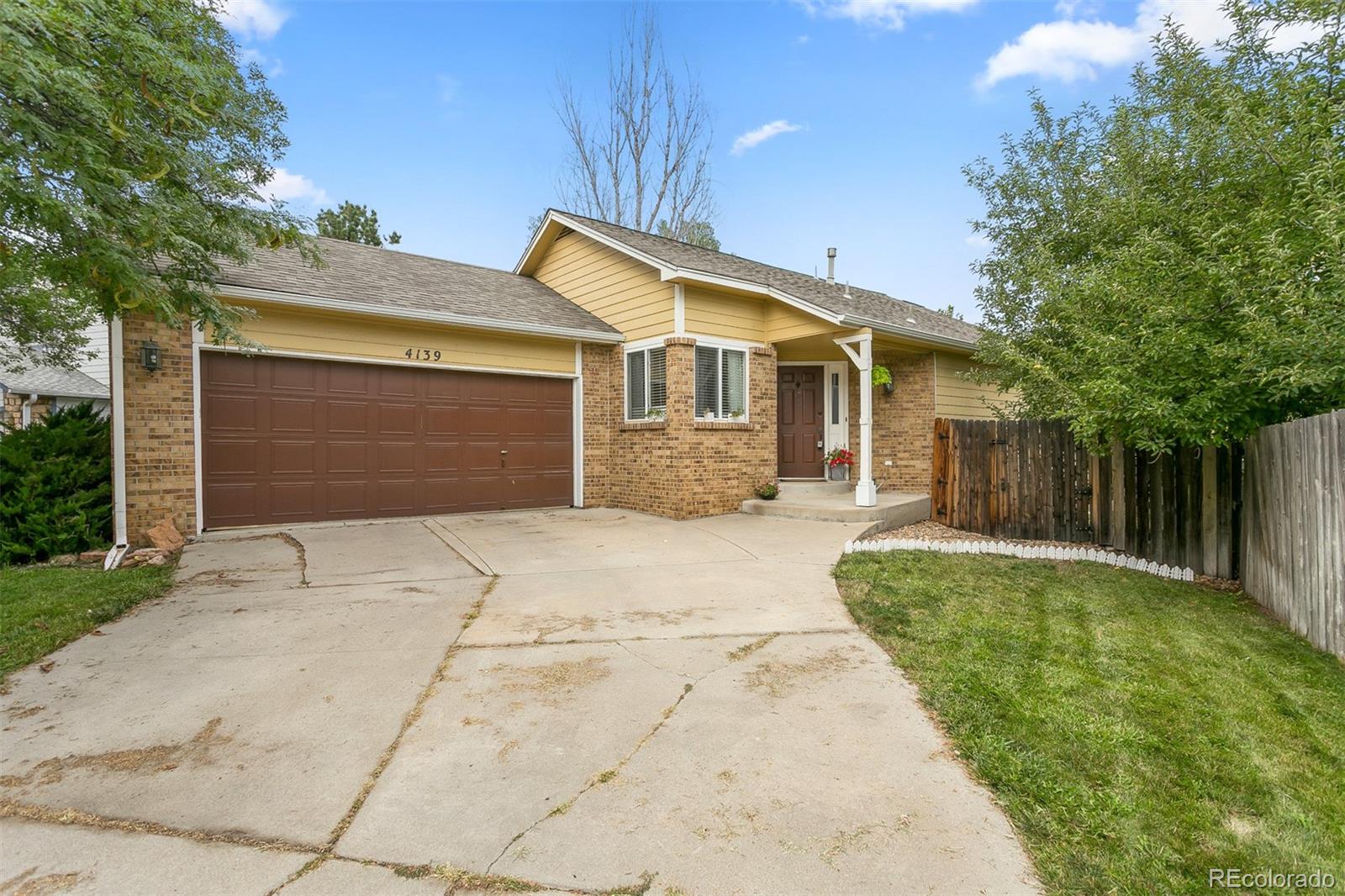 4139 East 131st Drive Thornton, CO 80241 - Photo 1 of 29 a front view of a house with a yard and garage