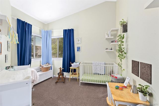 a bedroom with furniture and a large window