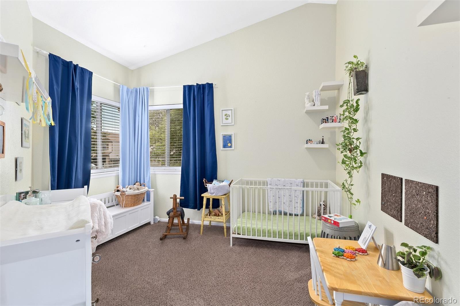 4139 East 131st Drive Thornton, CO 80241 - Photo 13 of 29 a bedroom with furniture and a large window
