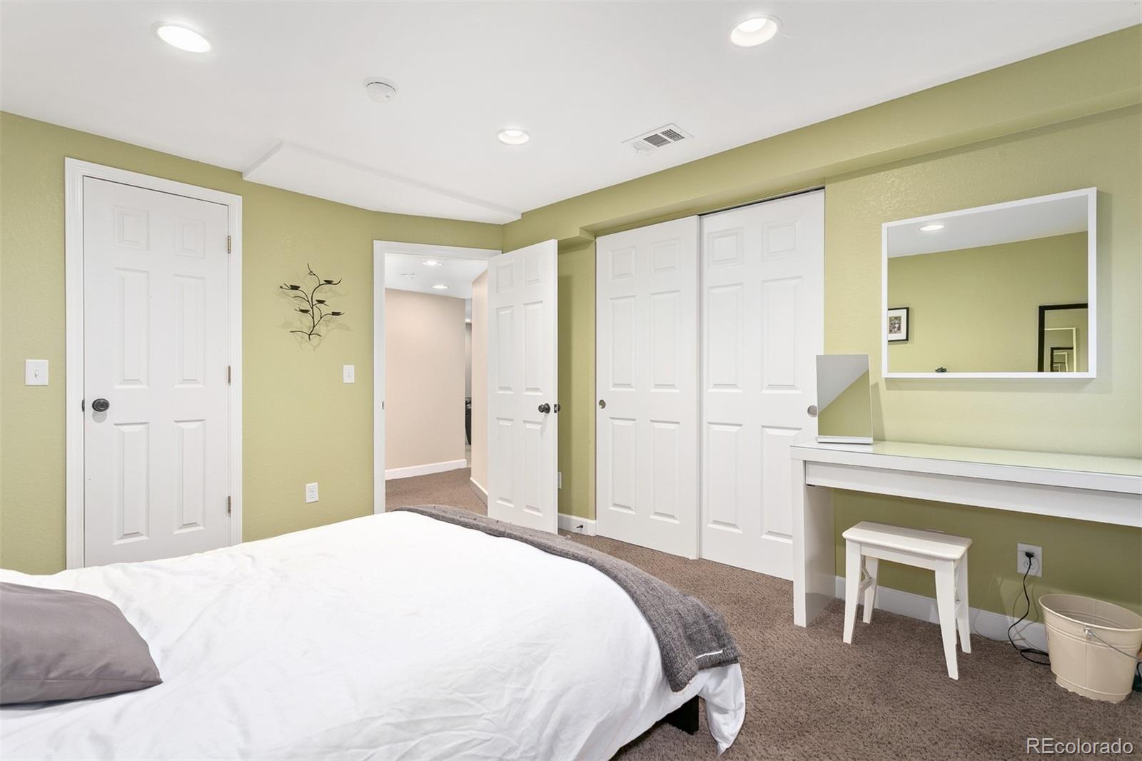 4139 East 131st Drive Thornton, CO 80241 - Photo 21 of 29 a bedroom with a bed and a dresser