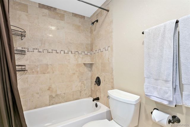 a bathroom with a shower a bathtub and a toilet