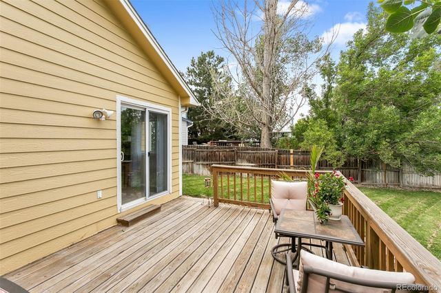 a balcony with wooden floor and furniture