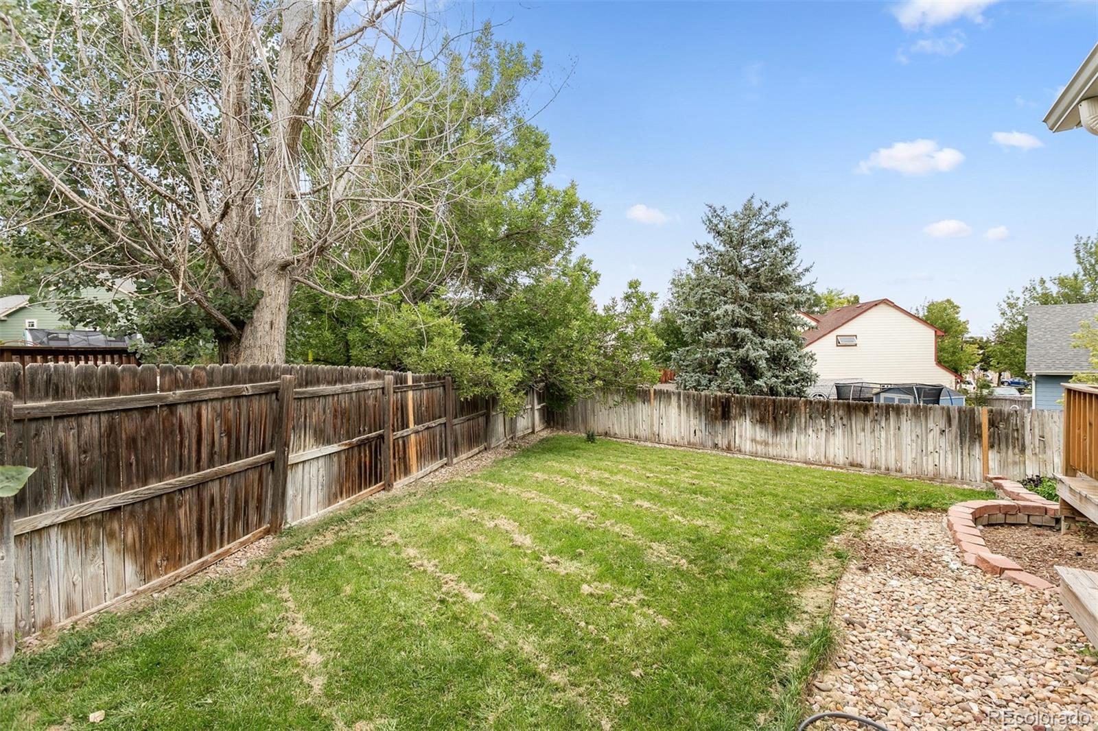 4139 East 131st Drive Thornton, CO 80241 - Photo 28 of 29 a view of a backyard with a small lake