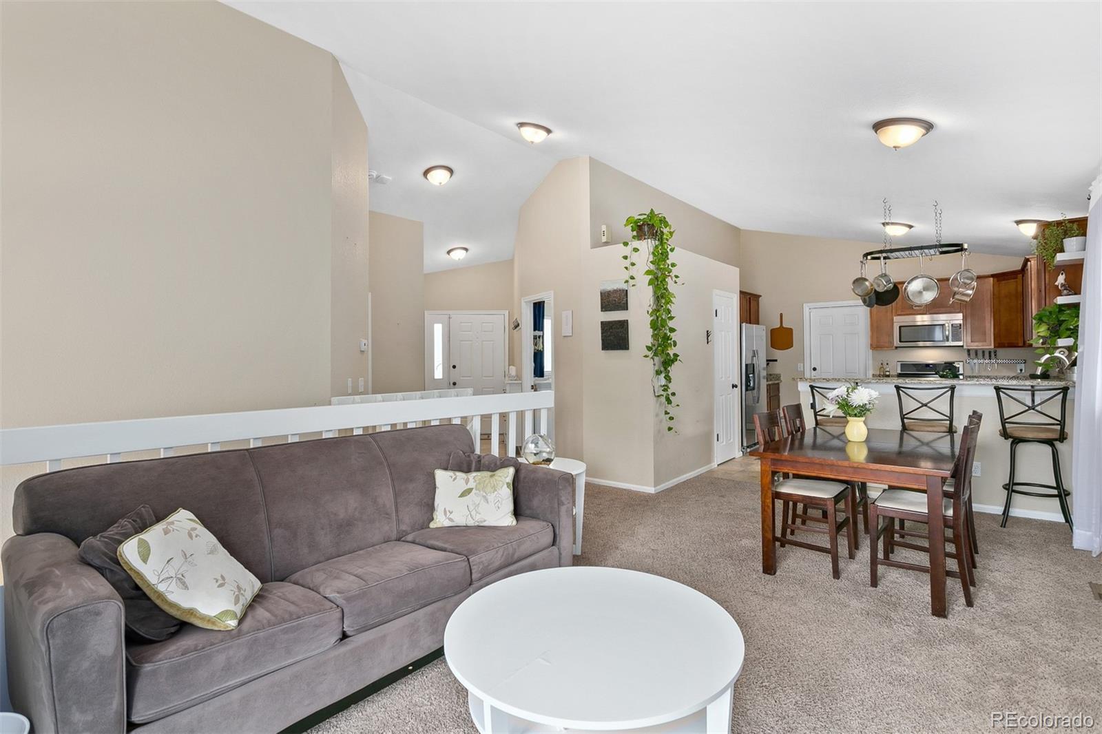 4139 East 131st Drive Thornton, CO 80241 - Photo 6 of 29 a living room with furniture and a table