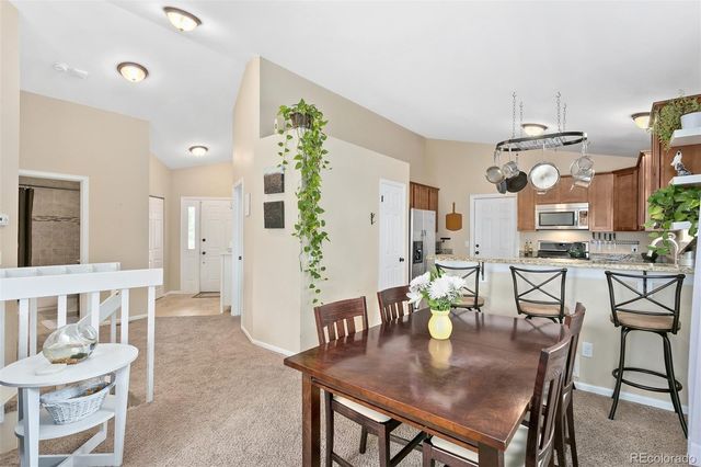 a view of a dining room with furniture and chandelier