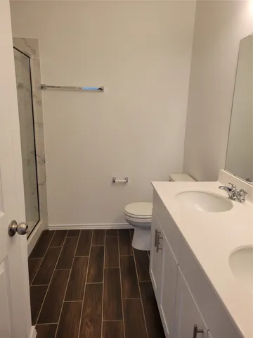 a bathroom with a glass shower door