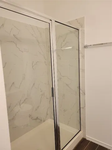 a bathroom with a glass shower door