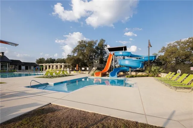 a view of a lake with a yard and a large parking space