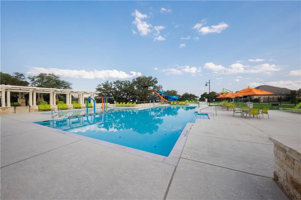 549 Pickrell Loop Georgetown, TX 78628 - Photo 24 of 26 a view of a lake with a yard and a large parking space