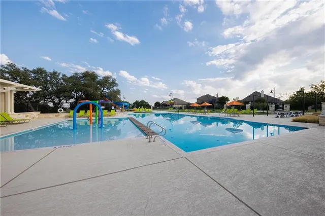 a view of a swimming pool with seating space