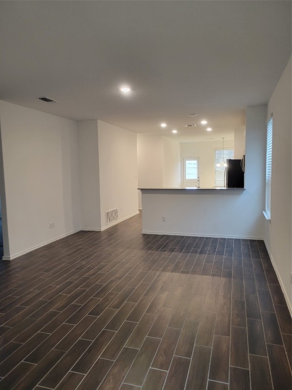 549 Pickrell Loop Georgetown, TX 78628 - Photo 4 of 26 an empty room with wooden floor and windows