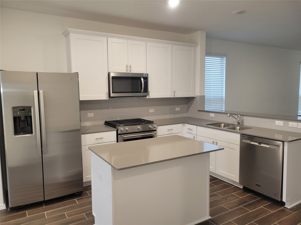 549 Pickrell Loop Georgetown, TX 78628 - Photo 7 of 26 a kitchen with a sink stove and refrigerator