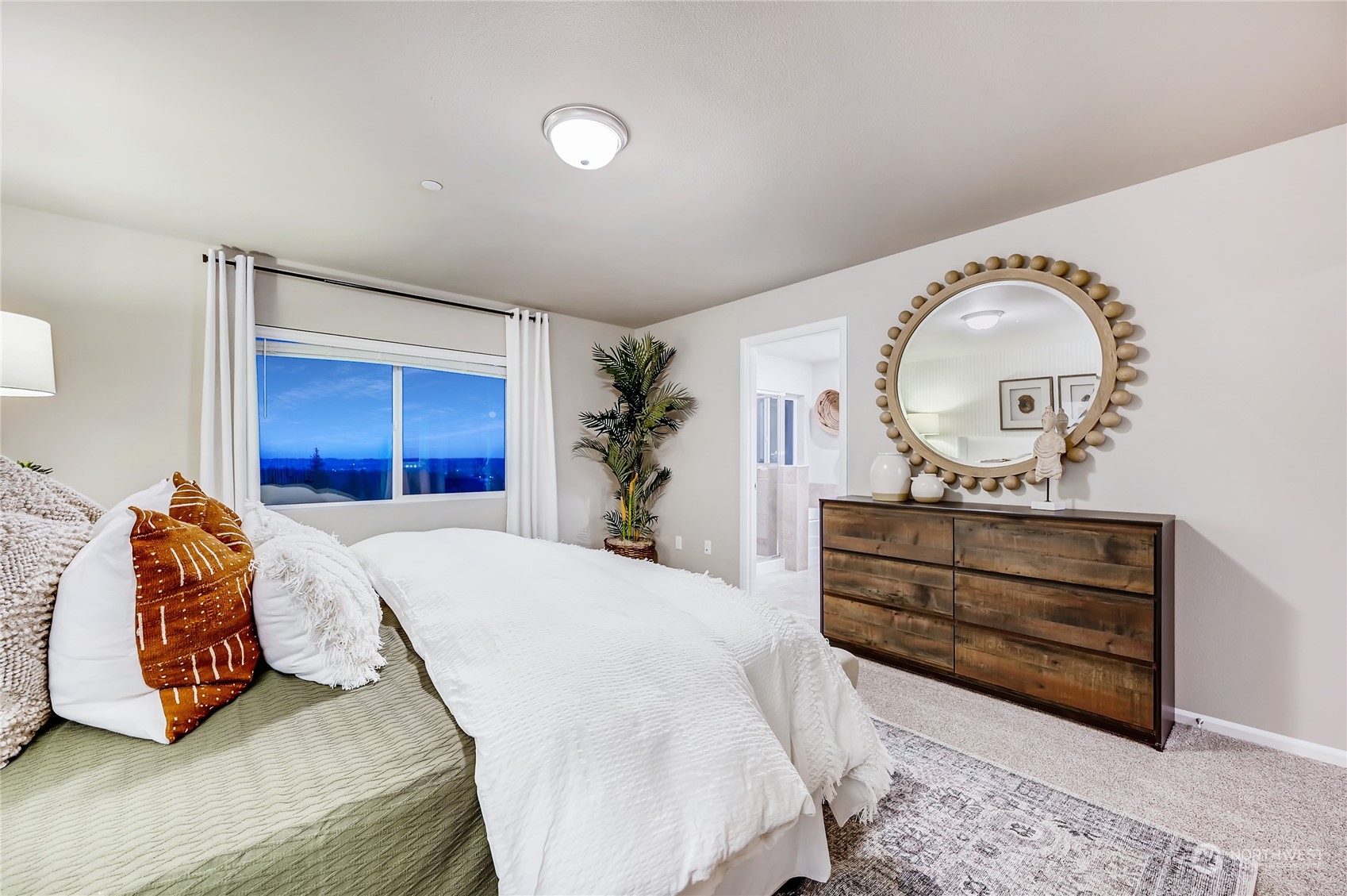 4393 Reef Road Southwest, Unit 3047 Port Orchard, WA 98367 - Photo 25 of 27 a bedroom with a bed and a mirror