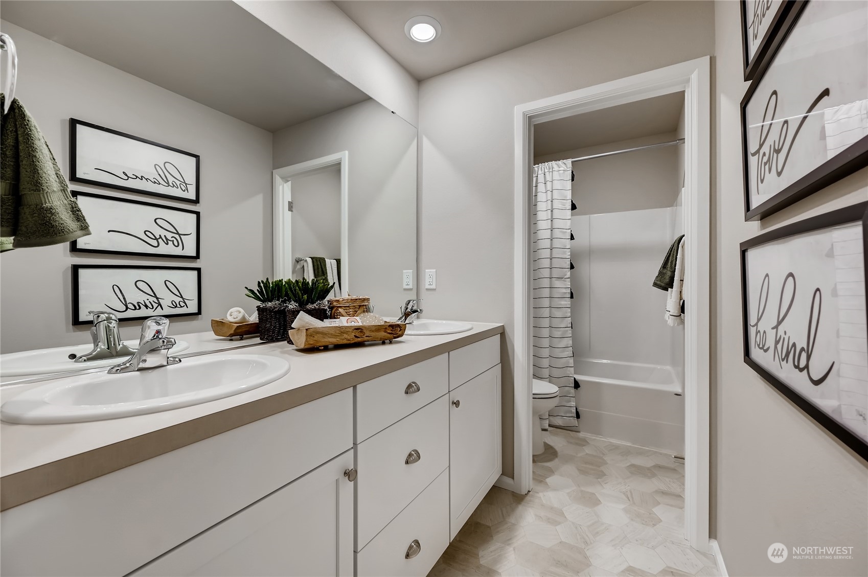 4393 Reef Road Southwest, Unit 3047 Port Orchard, WA 98367 - Photo 3 of 27 a bathroom with a double vanity sink a toilet and a mirror