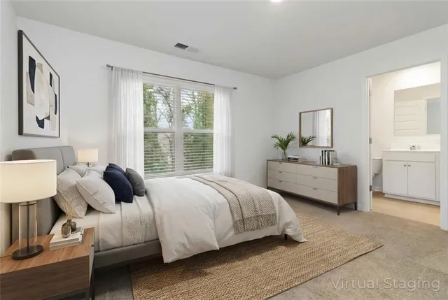 a bedroom with a bed and a large window