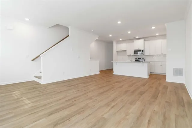 a view of a kitchen with a sink and a refrigerator