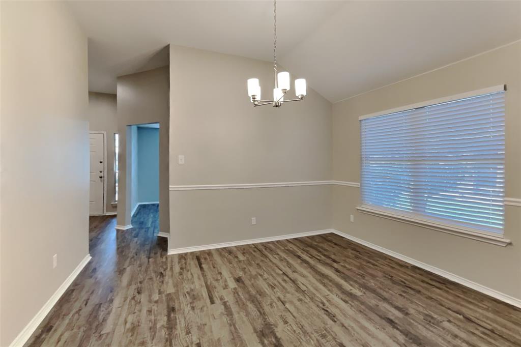 314 South Chestnut Street Forney, TX 75126 - Photo 5 of 18 Unfurnished dining area featuring dark wood-style floors, a chandelier, and high vaulted ceiling