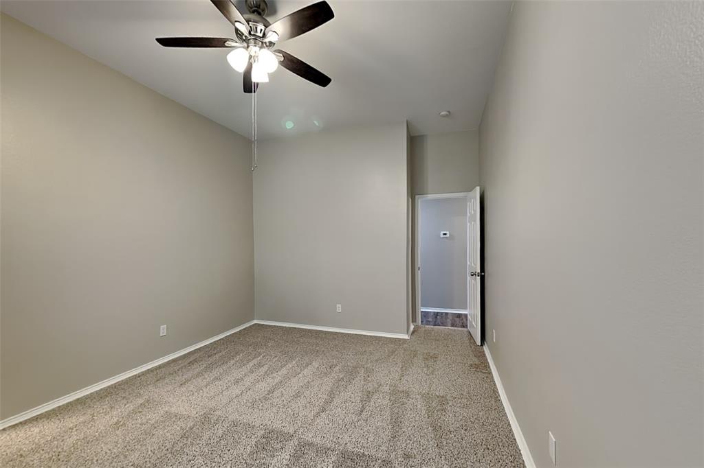 314 South Chestnut Street Forney, TX 75126 - Photo 7 of 18 Spare room featuring light carpet and a ceiling fan