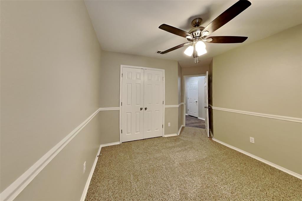 314 South Chestnut Street Forney, TX 75126 - Photo 10 of 18 Unfurnished bedroom with carpet flooring, ceiling fan, and a closet
