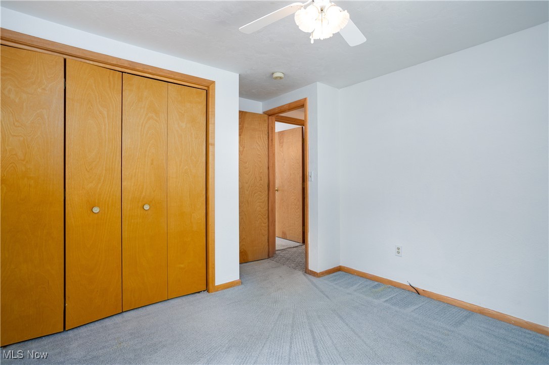 750 Silvercrest Road Wadsworth, OH 44281 - Photo 23 of 35 Unfurnished bedroom featuring light carpet, a ceiling fan, baseboards, and a closet