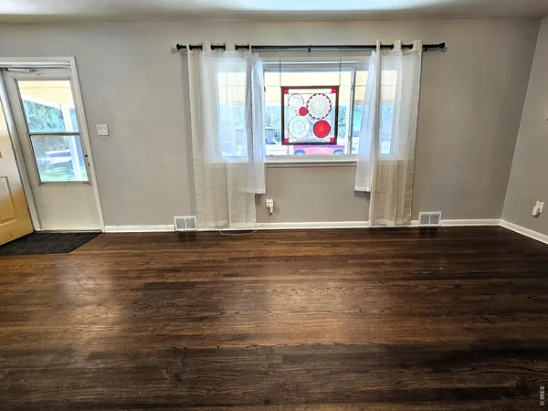a view of kitchen with wooden floor and window