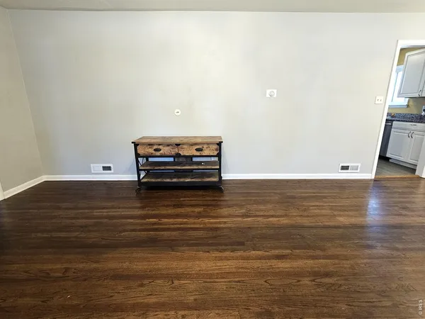 a view of a room with wooden floor