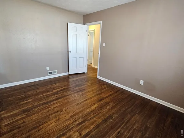 a table and chairs in a room next to a window