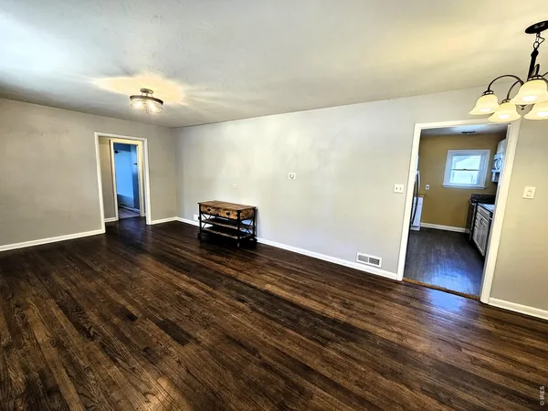 a view of a room with wooden floor