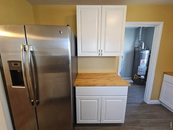 a bathroom with a granite countertop shower a sink and a stove