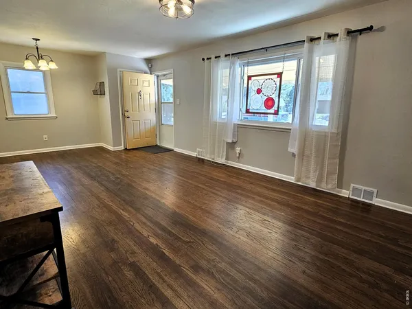 wooden floor with cabinet in an empty room