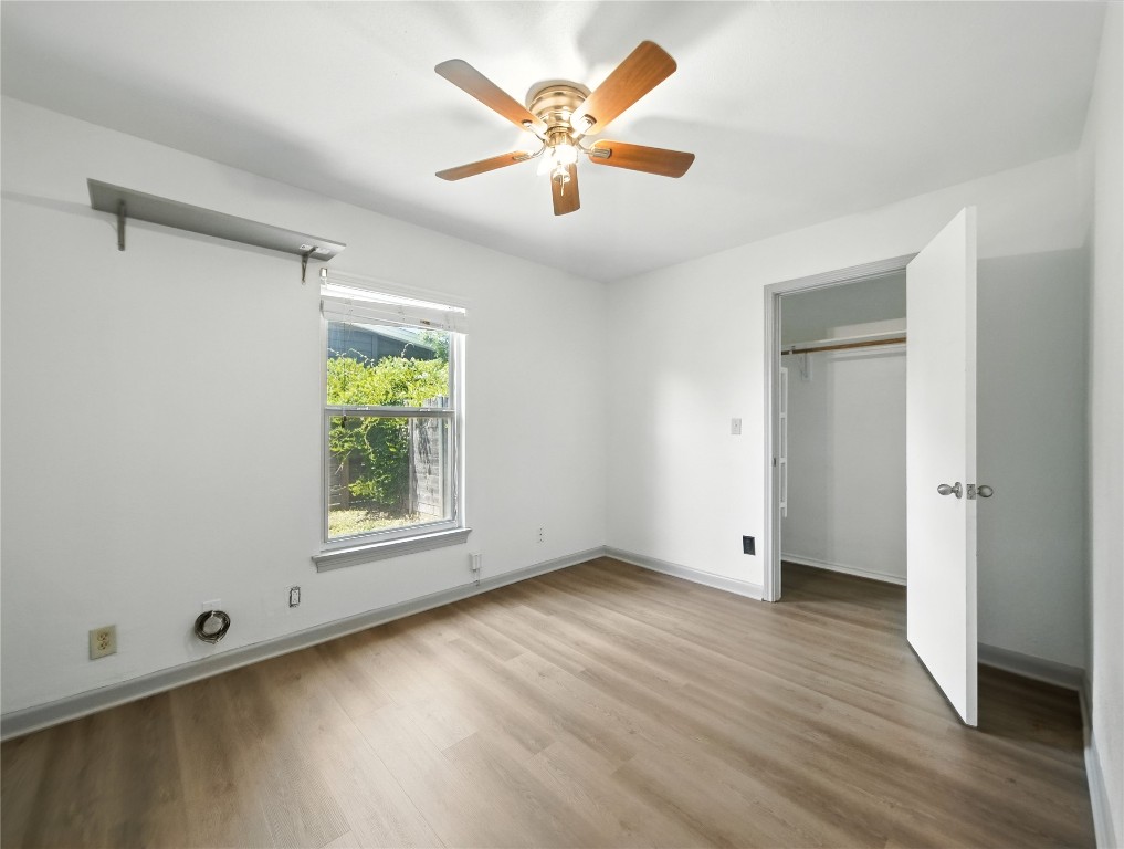 1604 Springdale Road Austin, TX 78721 - Photo 14 of 29 an empty room with wooden floor and windows