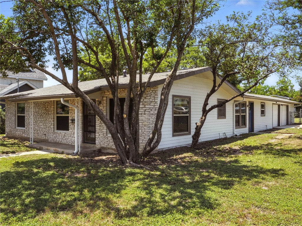 1604 Springdale Road Austin, TX 78721 - Photo 2 of 29 a front view of a house with a yard