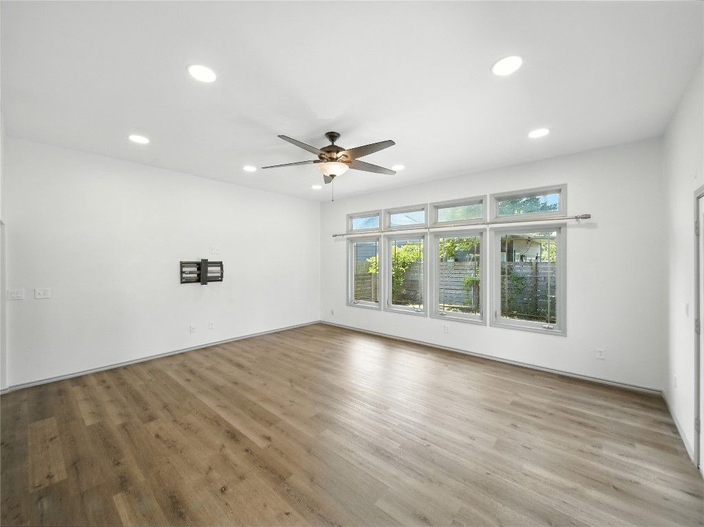 1604 Springdale Road Austin, TX 78721 - Photo 3 of 29 a view of an empty room with a window and wooden floor