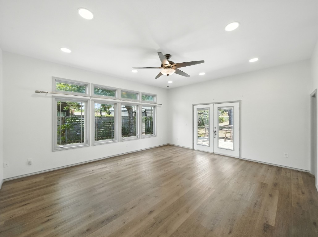 1604 Springdale Road Austin, TX 78721 - Photo 4 of 29 a view of an empty room with a window and wooden floor