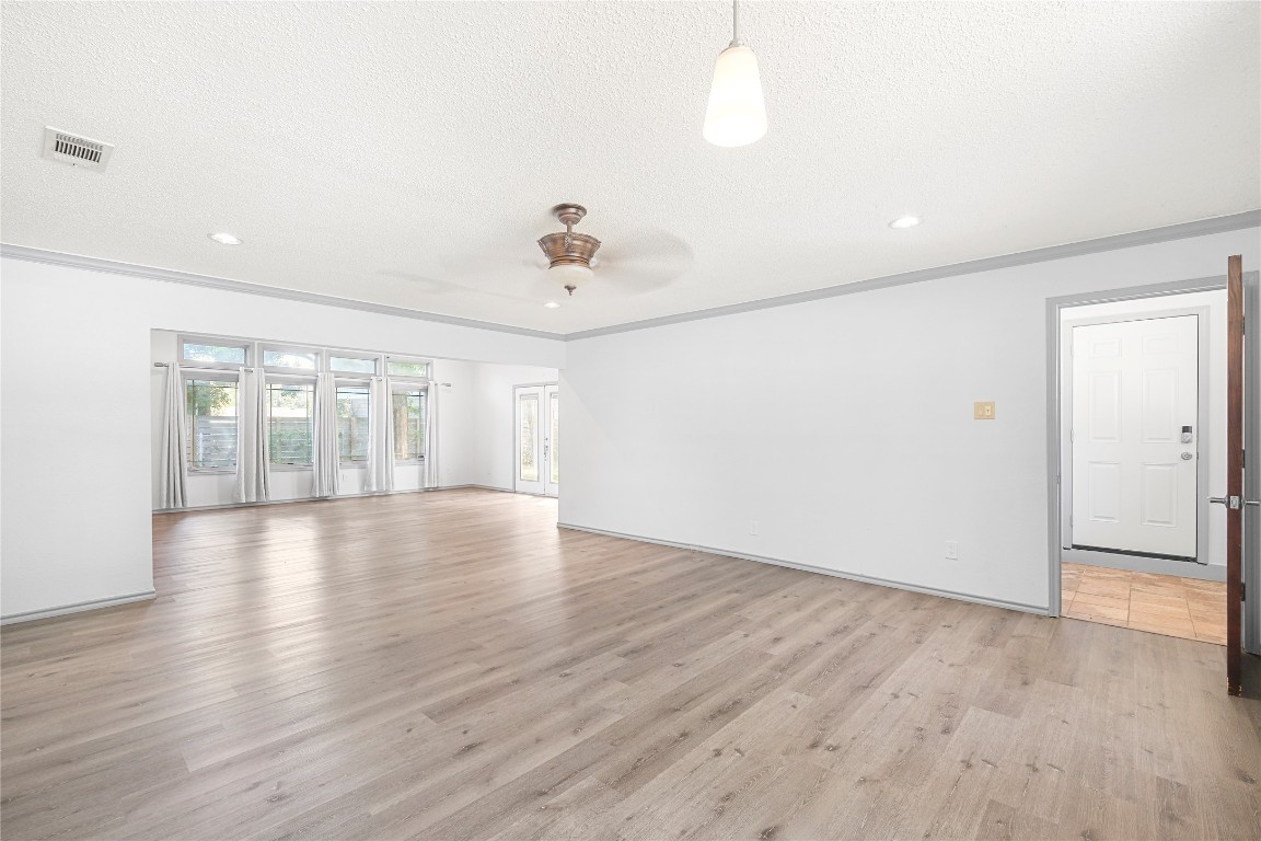 1604 Springdale Road Austin, TX 78721 - Photo 6 of 29 wooden floor in an empty room with a window